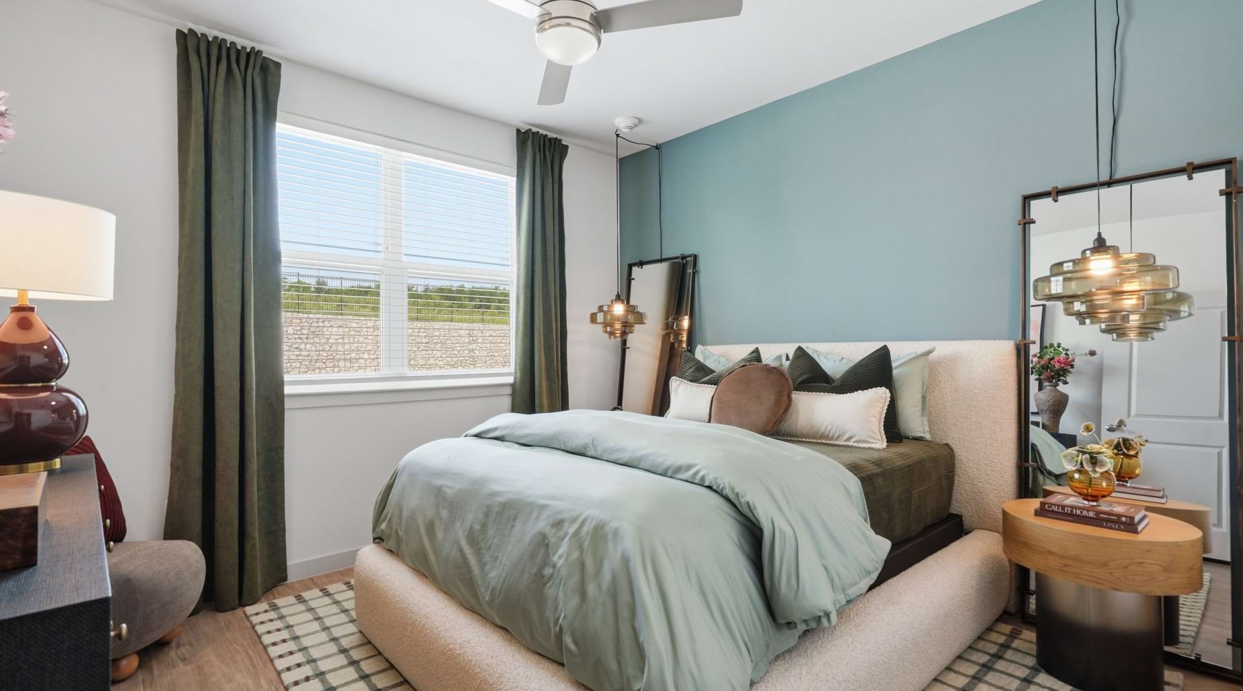 a bedroom with a bed, a nightstand and a dresser