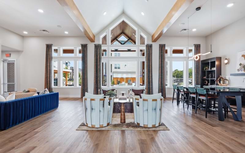 clubhouse with chairs, table and large windows