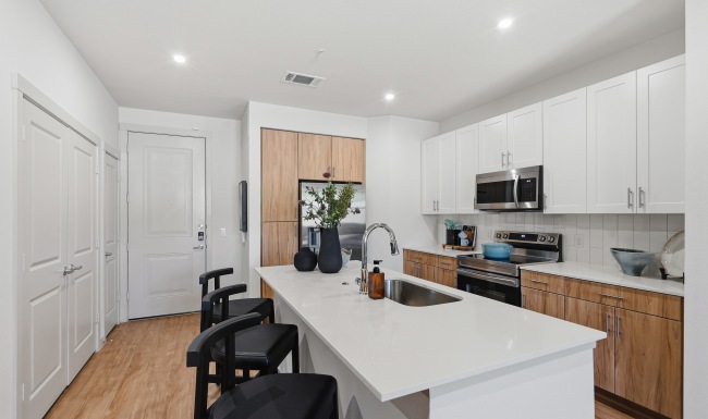 kitchen island with sink, cabinets and shelves
