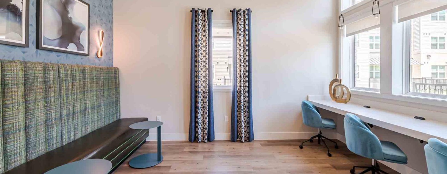 a room with a table chairs and a window